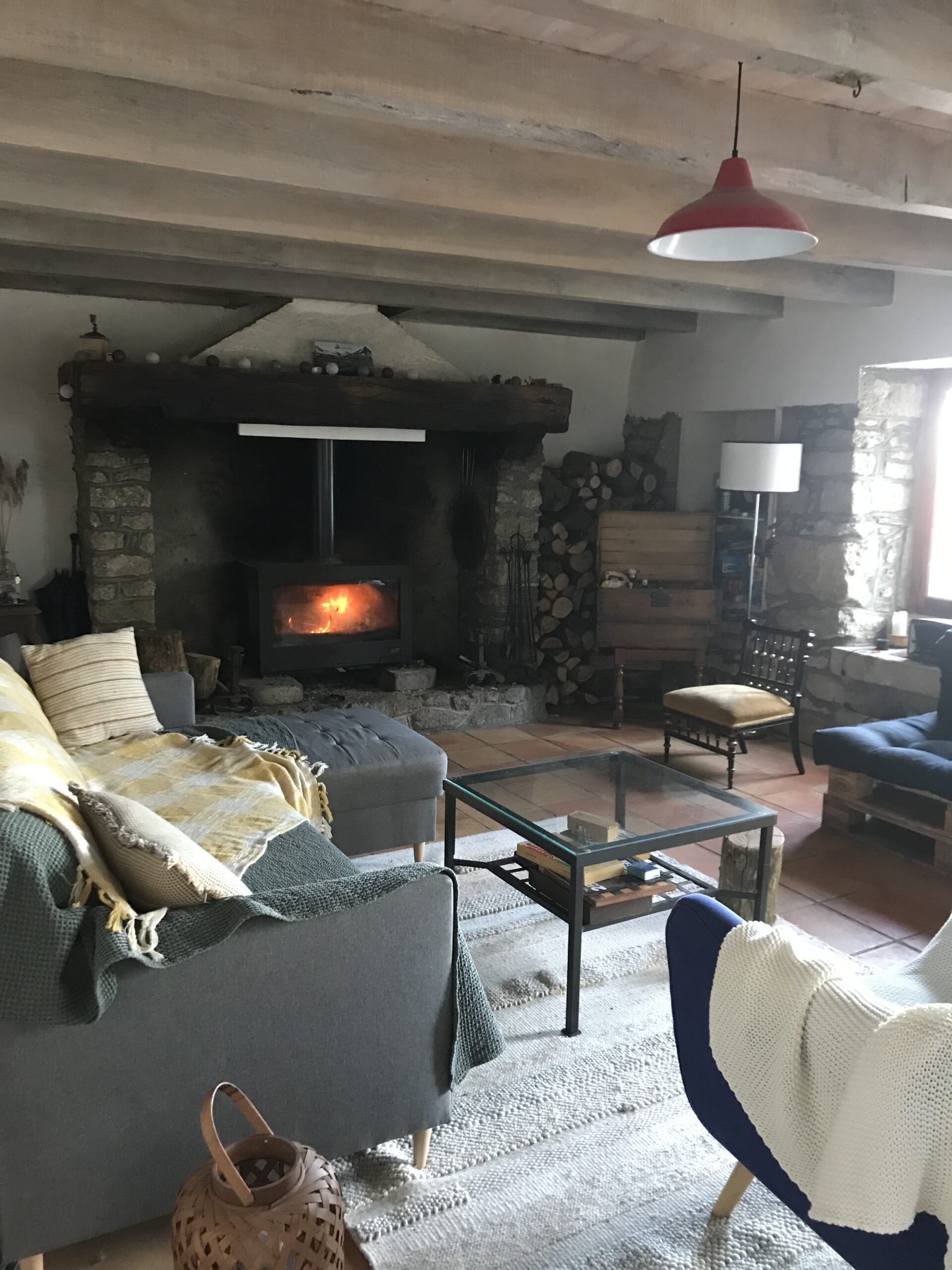 Vue sur la table basse et le poêle à bois allumé